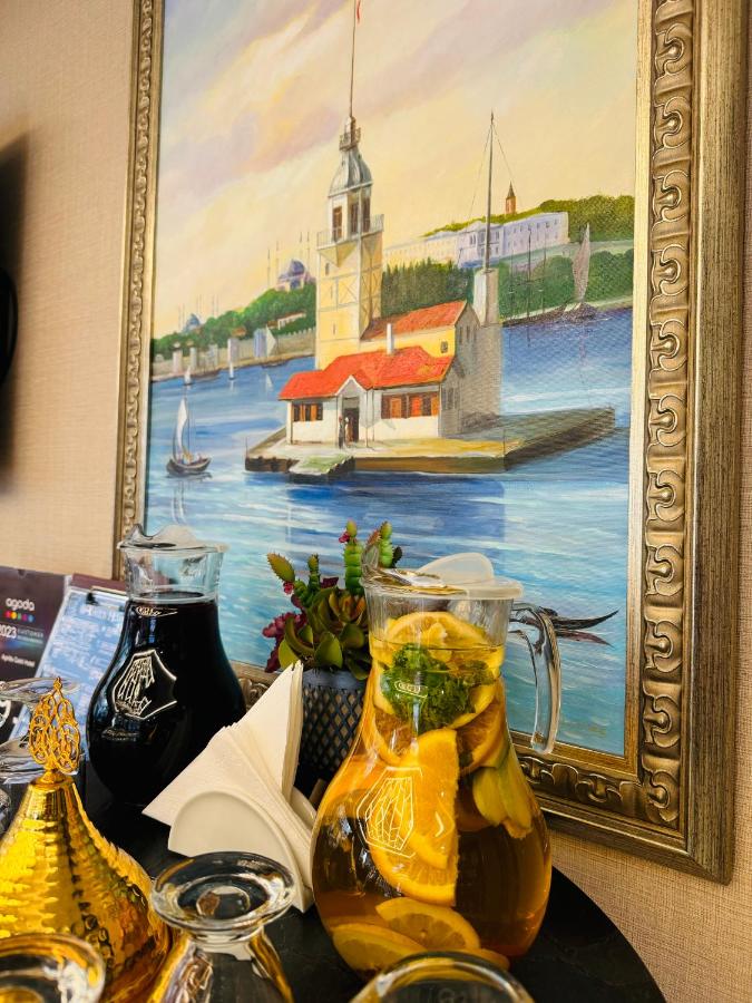 een afbeelding van een schilderij van een vuurtoren en een kan sap bij Aprilis Gold Hotel - Special Category in Istanbul