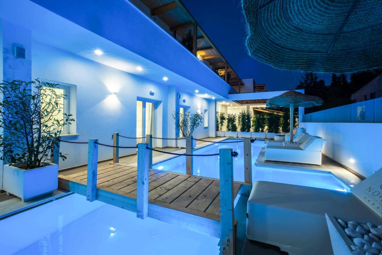 een huis met een zwembad 's nachts bij NOHA Lifestyle Hotel - Adults Only in Pula