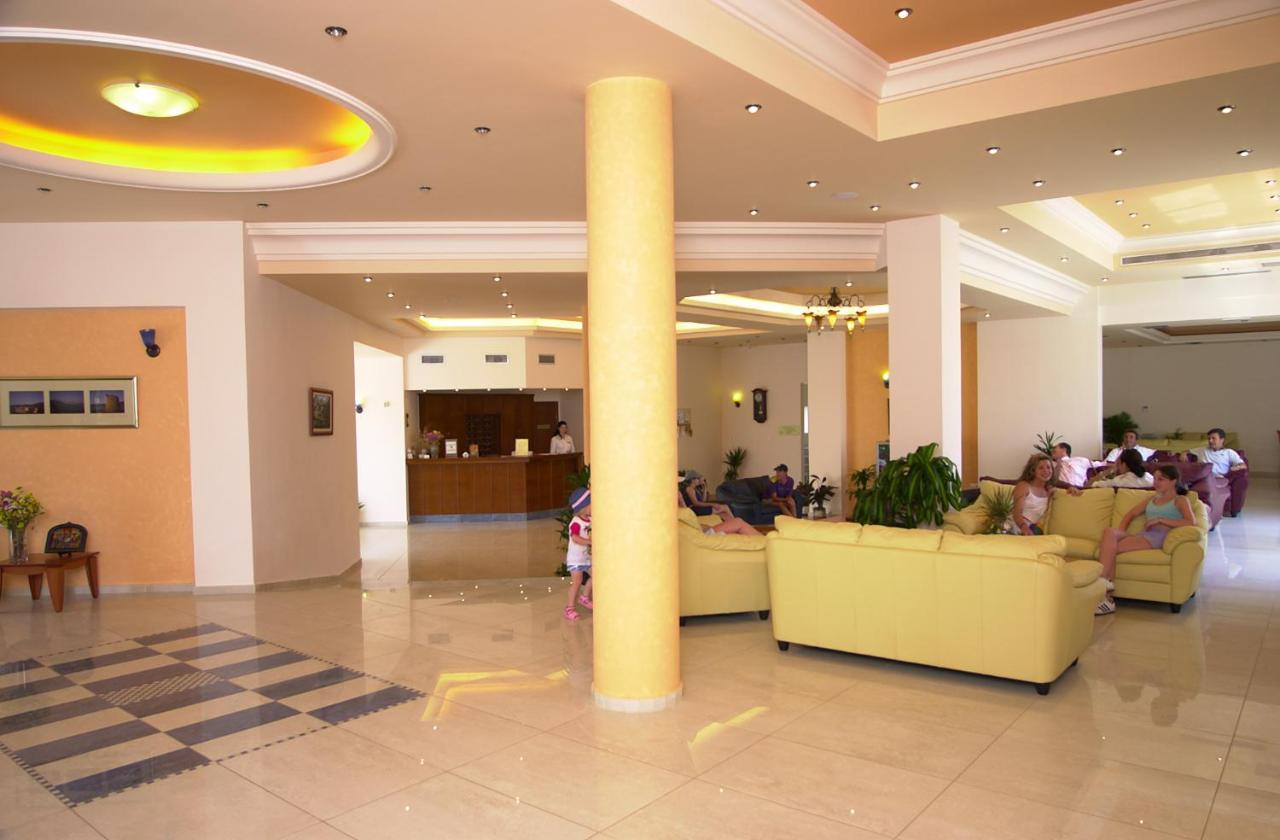 een lobby met een kolom in het midden van een gebouw bij Blue Aegean Hotel & Suites in Gouves +53 foto's