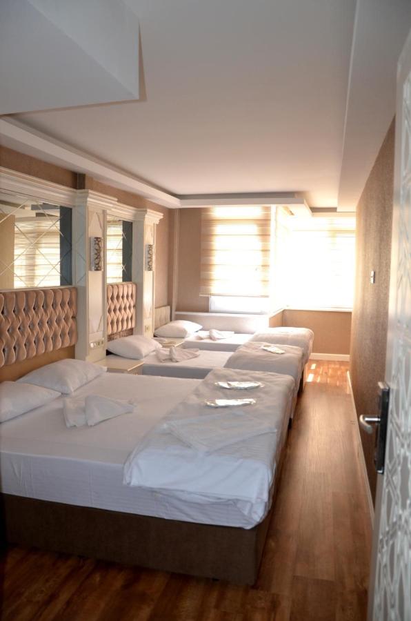 een kamer met vier bedden op een rij bij Sun Comfort Hotel in Istanbul +57 foto's