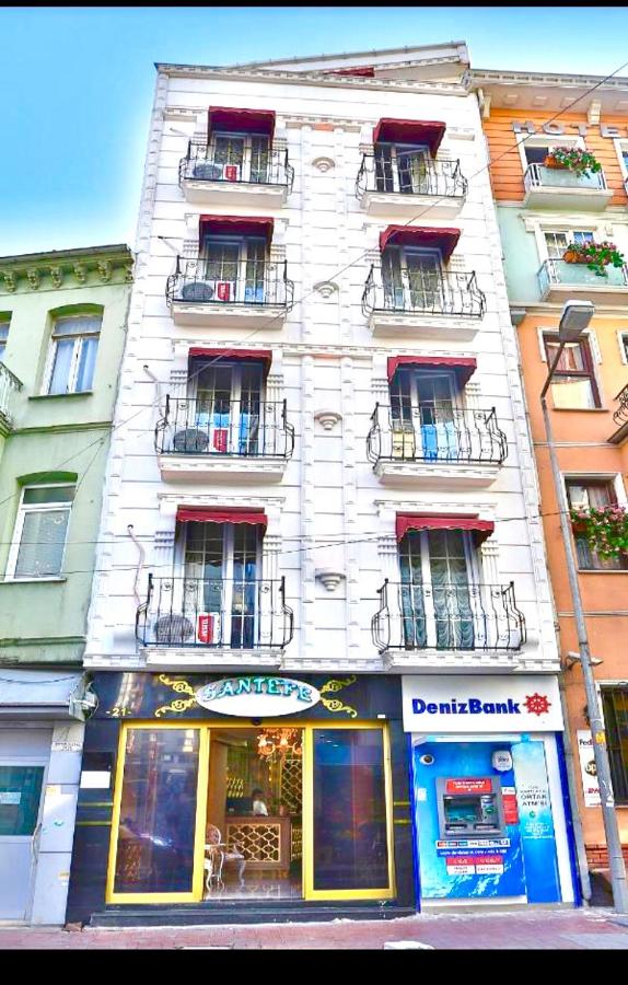 een hoog wit gebouw met balkons aan een stadsstraat bij Santefe Hotel in Istanbul
