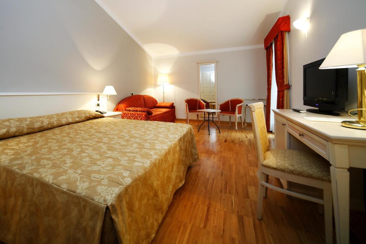 een hotelkamer met een bed en een televisie bij Hotel Terminal in Milaan