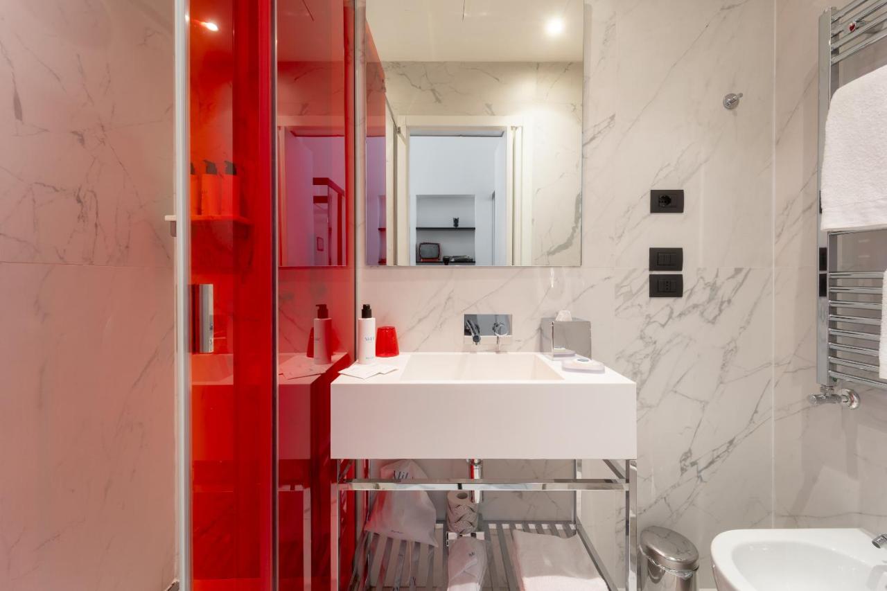 een badkamer met een witte wastafel en een spiegel bij Hotel Milu Florence in Florence +84 foto's