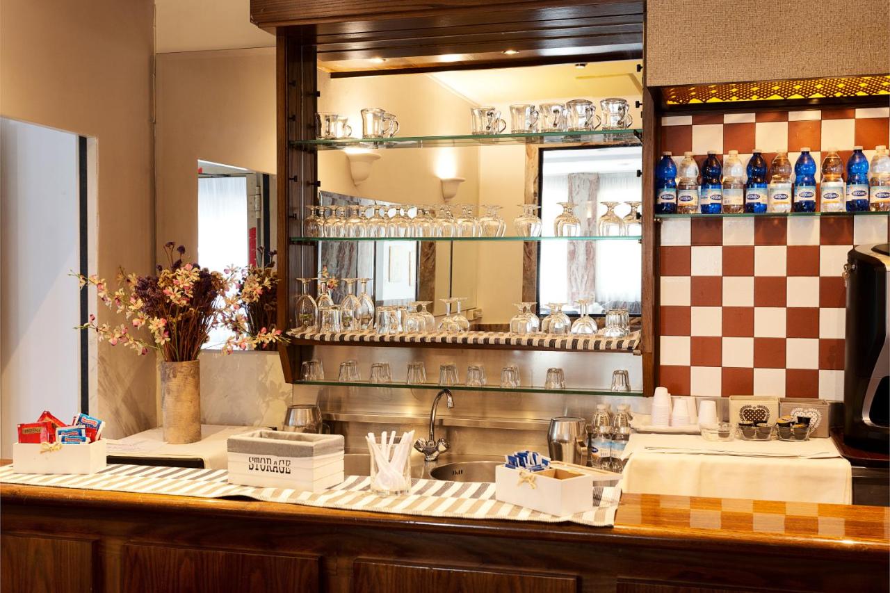een keuken met een aanrecht met een spiegel en een spoelbak bij Hotel Corolle in Florence