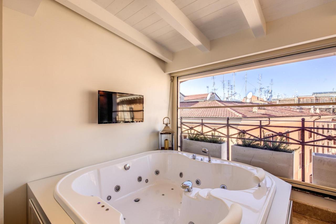een badkuip in een badkamer met een groot raam bij Hotel Domus Mea in Rome