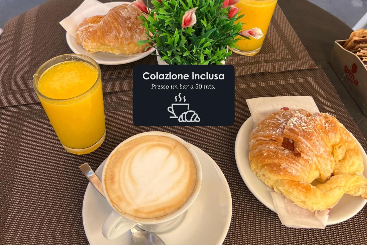 een tafel met een kop koffie, croissants en sinaasappelsap bij Floor 6 Boutique Rooms by DOT Suites in Rome