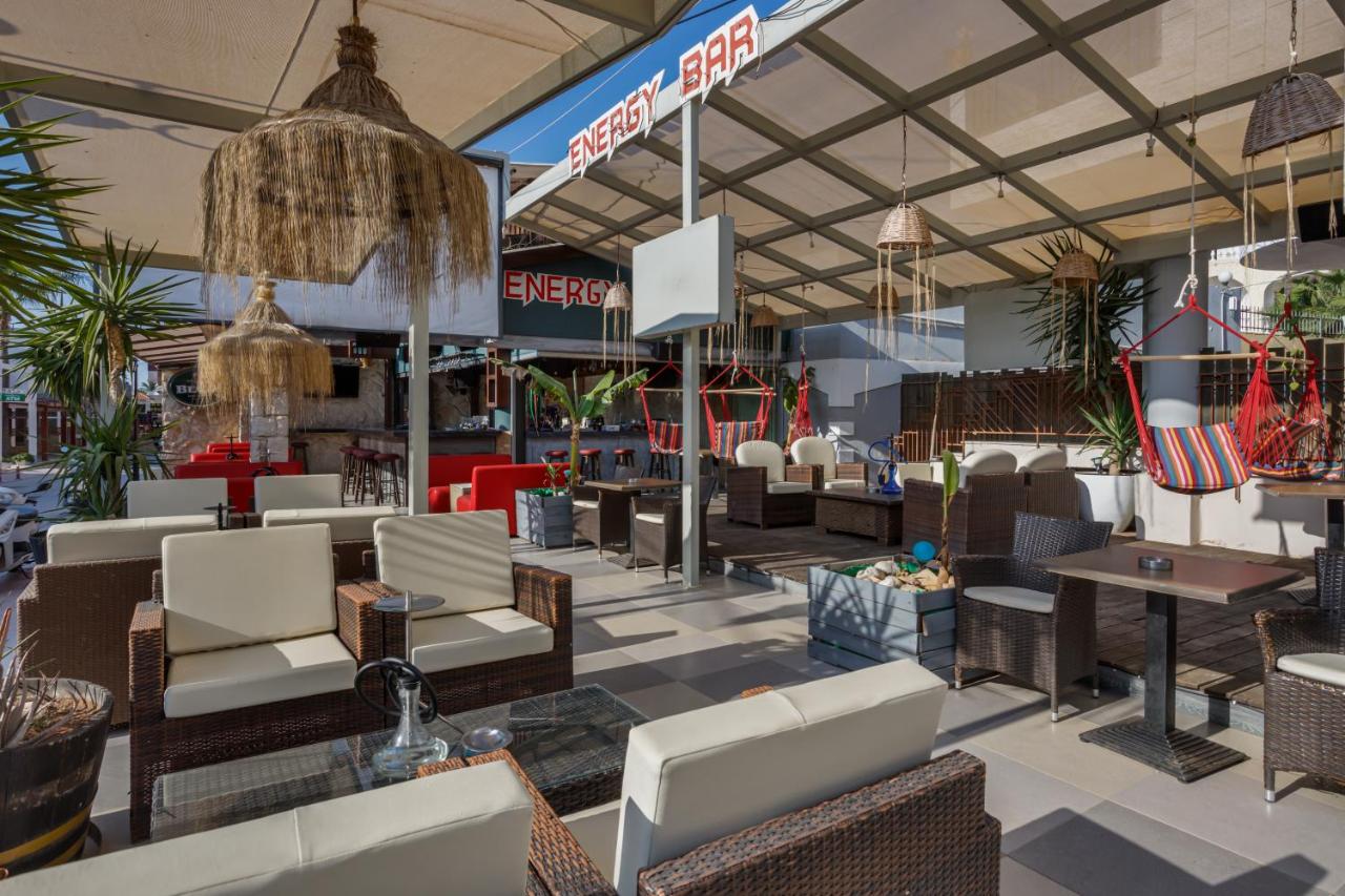 een restaurant met banken, tafels en stoelen bij Malia Energy by Estia in Malia