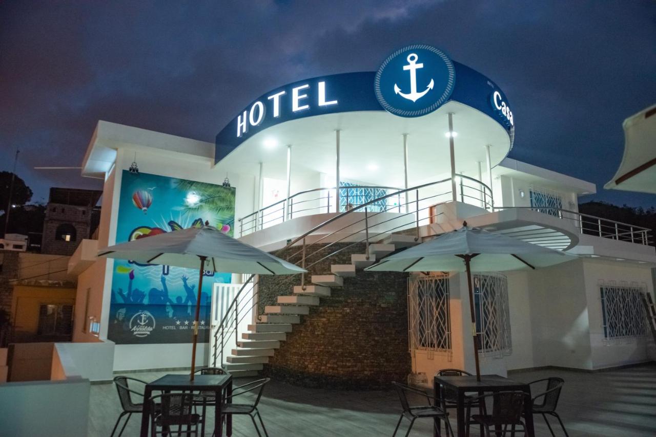 een hotel met tafels en parasols ervoor bij Hotel Casa Arnaldo "Esmeraldas" in Esmeraldas