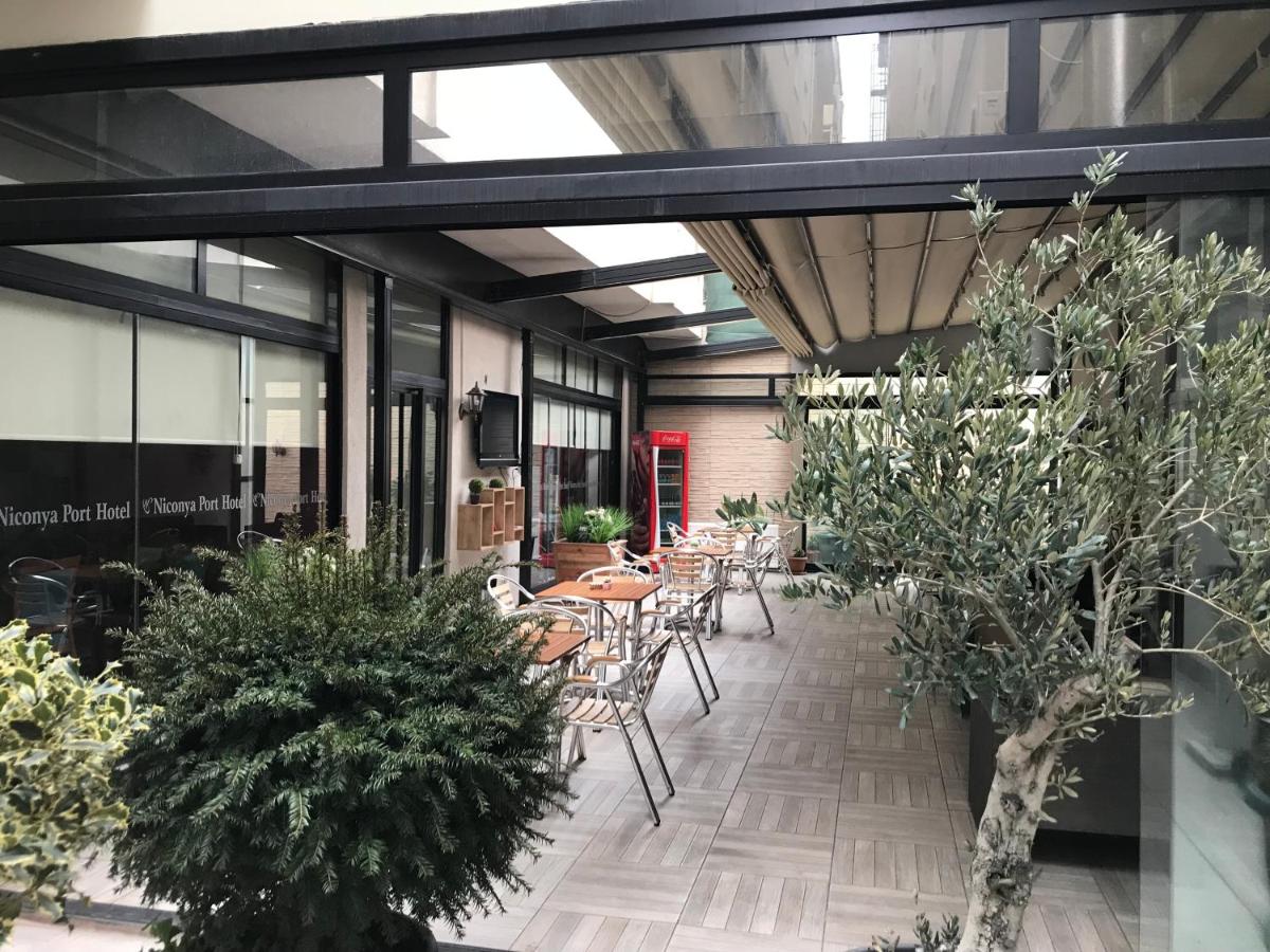 een terras met tafels en stoelen en planten bij Niconya Port Suite&Hotel in Istanbul