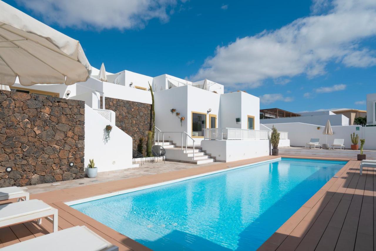 een villa met een zwembad voor een huis bij La Concha Boutique Apartments - Adults Only in Arrecife