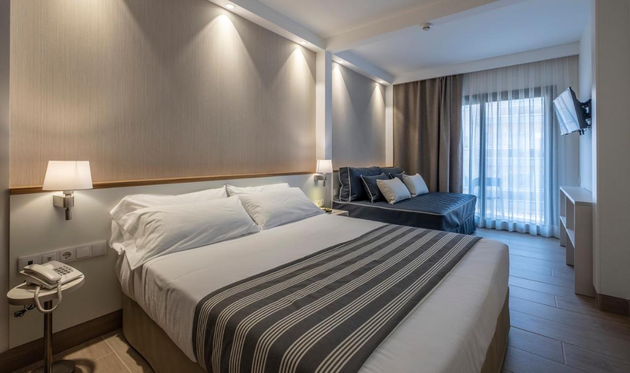 een hotelkamer met een bed en een stoel bij Rosamar Es Blau 4*s - Adults Only in Lloret de Mar
