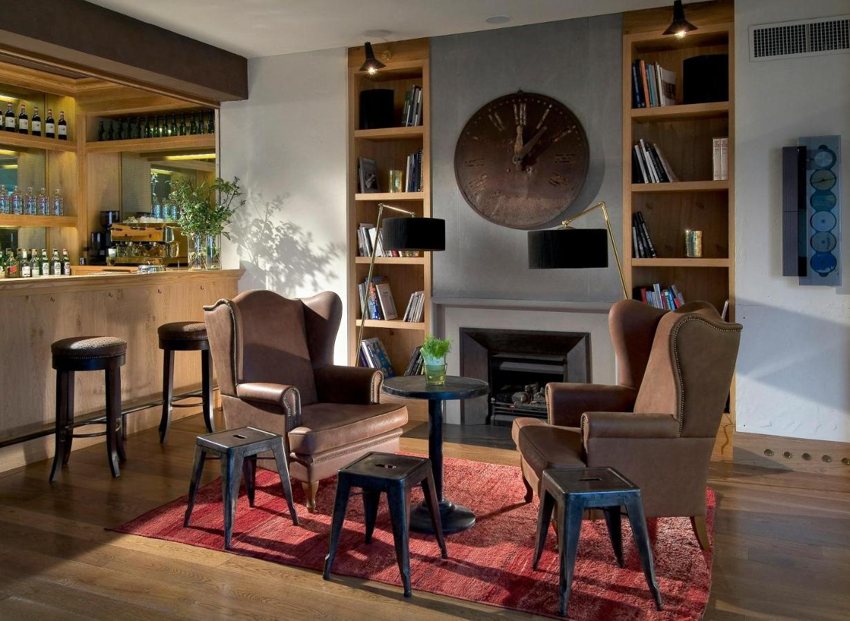 een bar met stoelen, een open haard en een klok bij Starhotels Tuscany in Florence