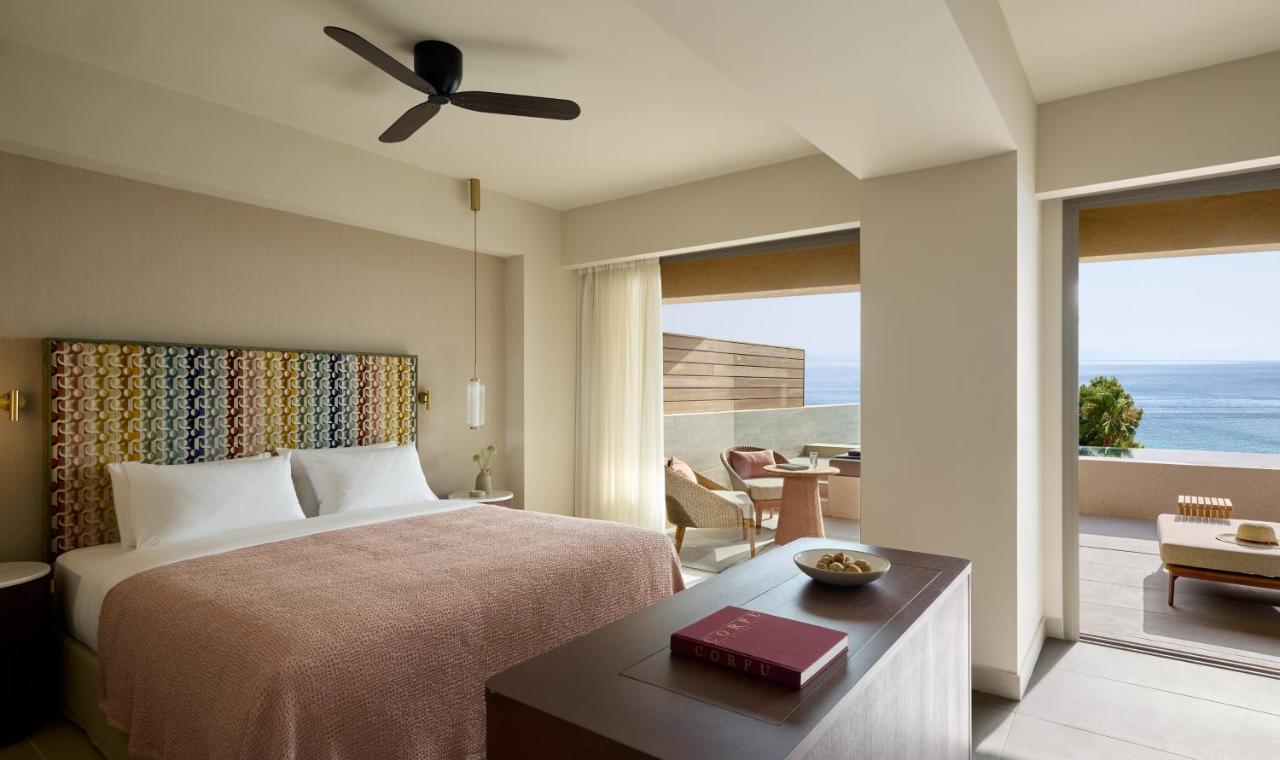een slaapkamer met een bed en uitzicht op de oceaan bij Avali, Mar-Bella Collection in Agios Ioannis Peristerion