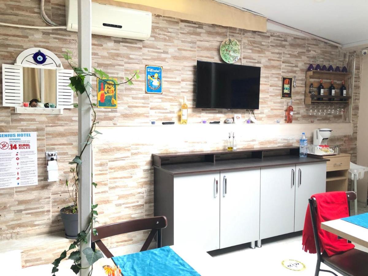 een keuken met een tv aan een bakstenen muur bij Genius Hotel Istanbul in Istanbul