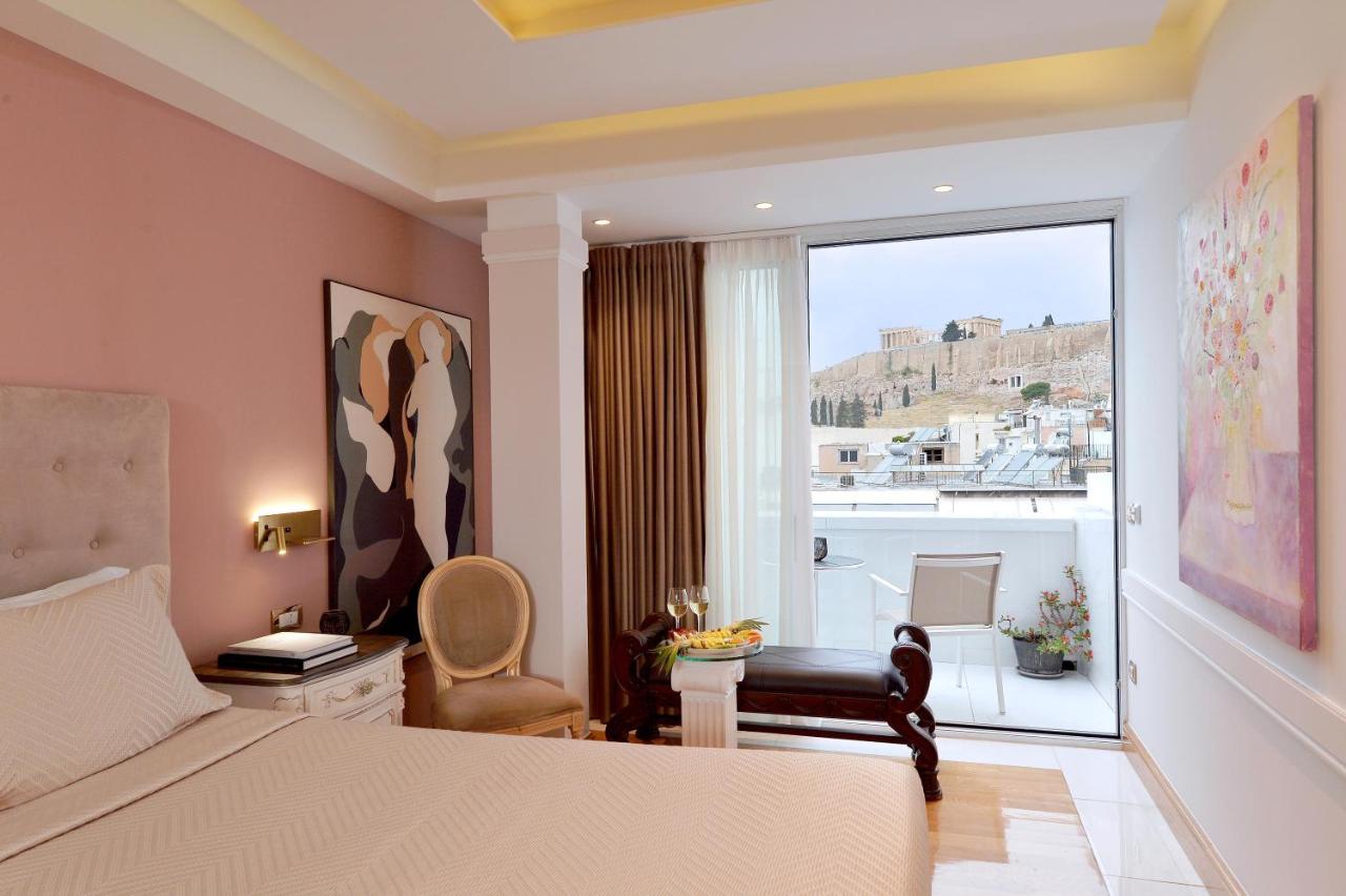 een slaapkamer met een bed en een groot raam bij Acropolian Spirit Boutique Hotel in Athene