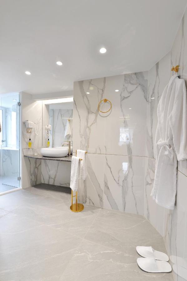 een witte badkamer met een marmeren muur bij Acropolian Spirit Boutique Hotel in Athene