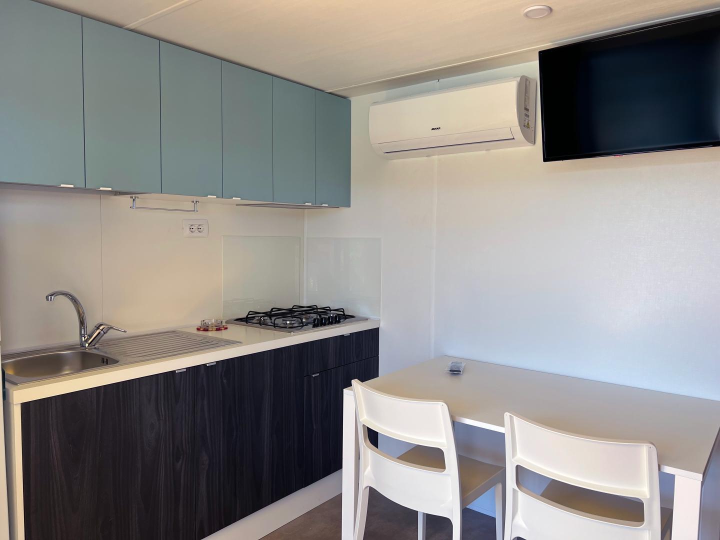 Suite met zithoek — Camping Village Capo D'Orso