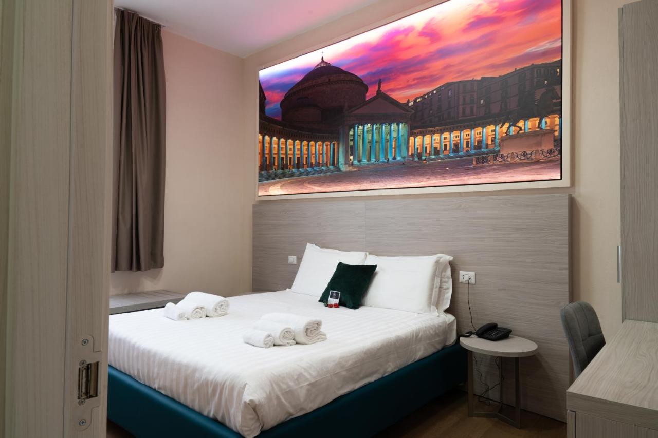 een hotelkamer met een bed en handdoeken erop bij THE SUN HOTEL BOUTIQUE NAPOLI in Napels
