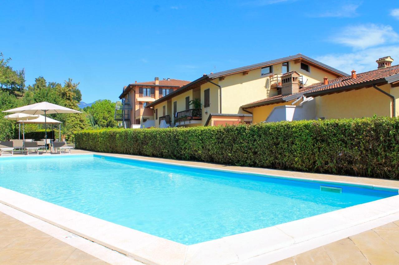 een zwembad voor een huis bij AHG Donna Silvia Wellness Hotel in Manerba del Garda