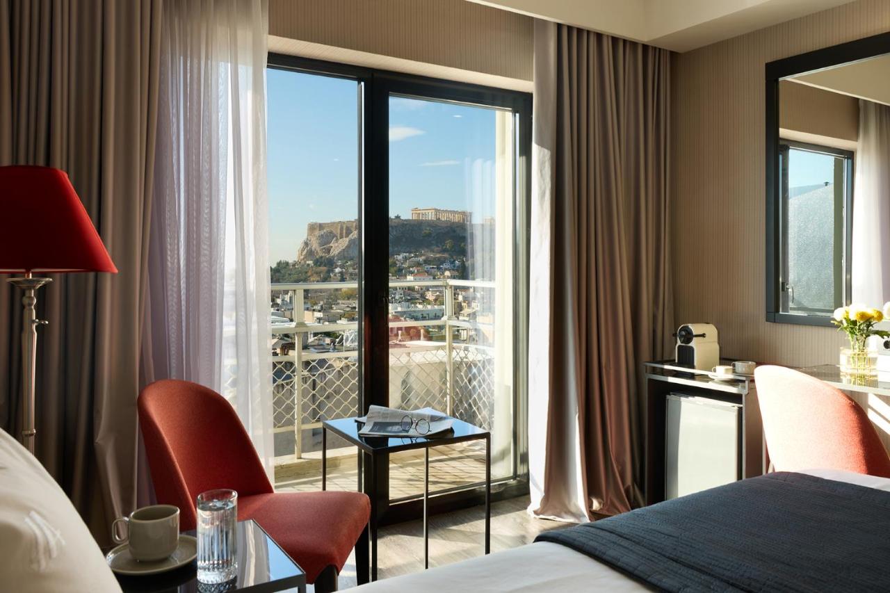 een hotelkamer met een bed en een groot raam bij Astor Hotel Athens in Athene +88 foto's