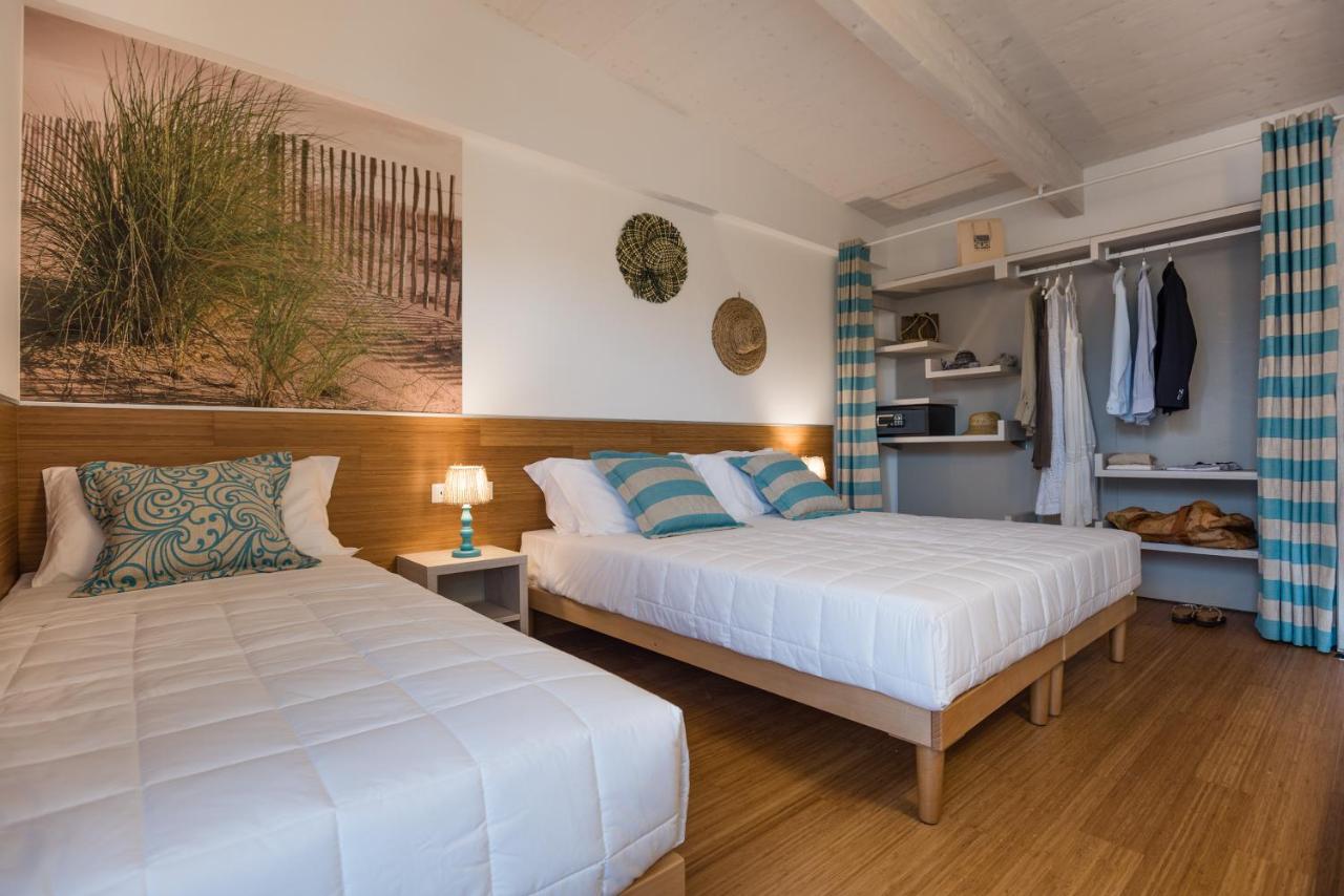 twee bedden in een kamer met twee bedden sidx sidx sidx sidx bij Lino delle Fate Eco Resort in Bibione