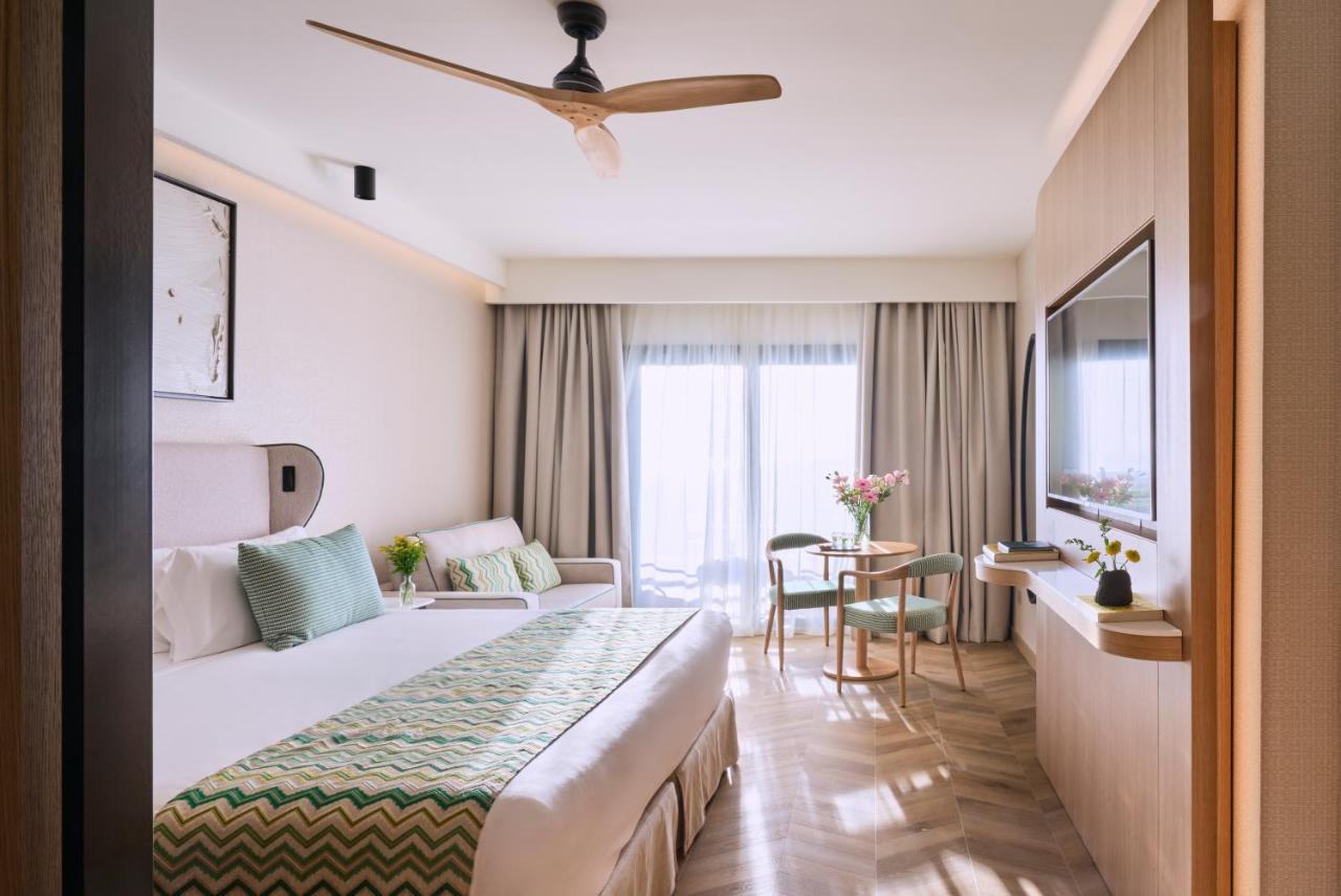 een hotelkamer met een groot bed en een tafel bij Barceló Punta Umbría Mar in Punta Umbría