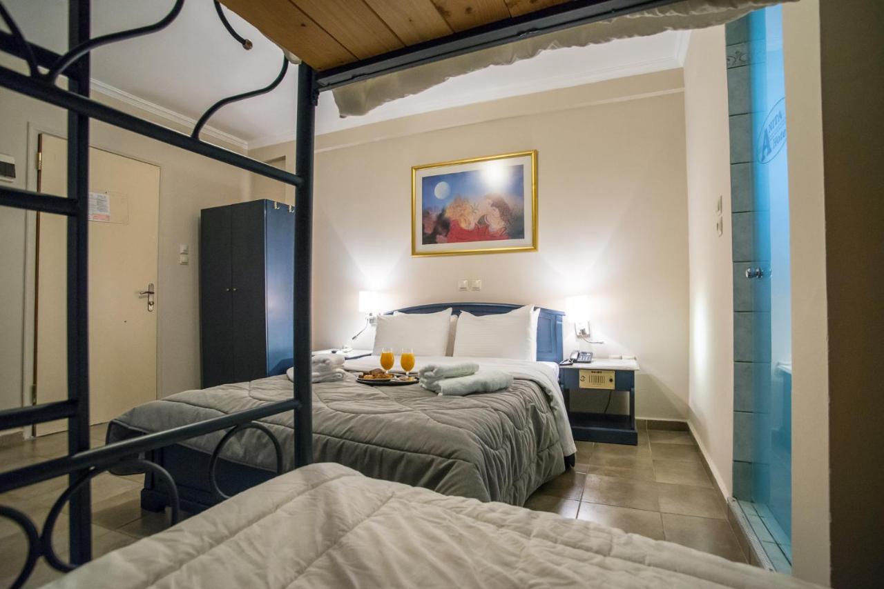 een slaapkamer met twee bedden in een kamer bij Anita Hotel in Piraeus