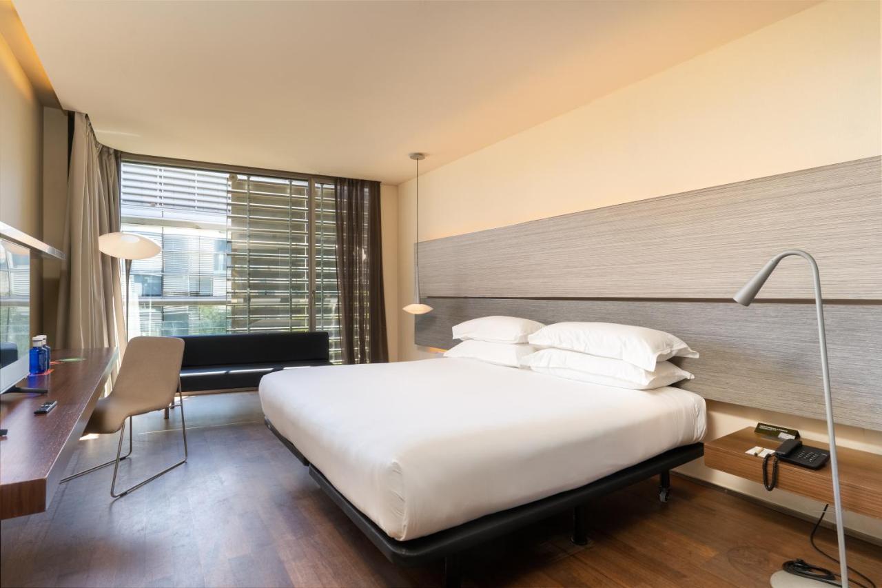een hotelkamer met een groot bed en een bureau en een bureau bij B Hotel in Barcelona