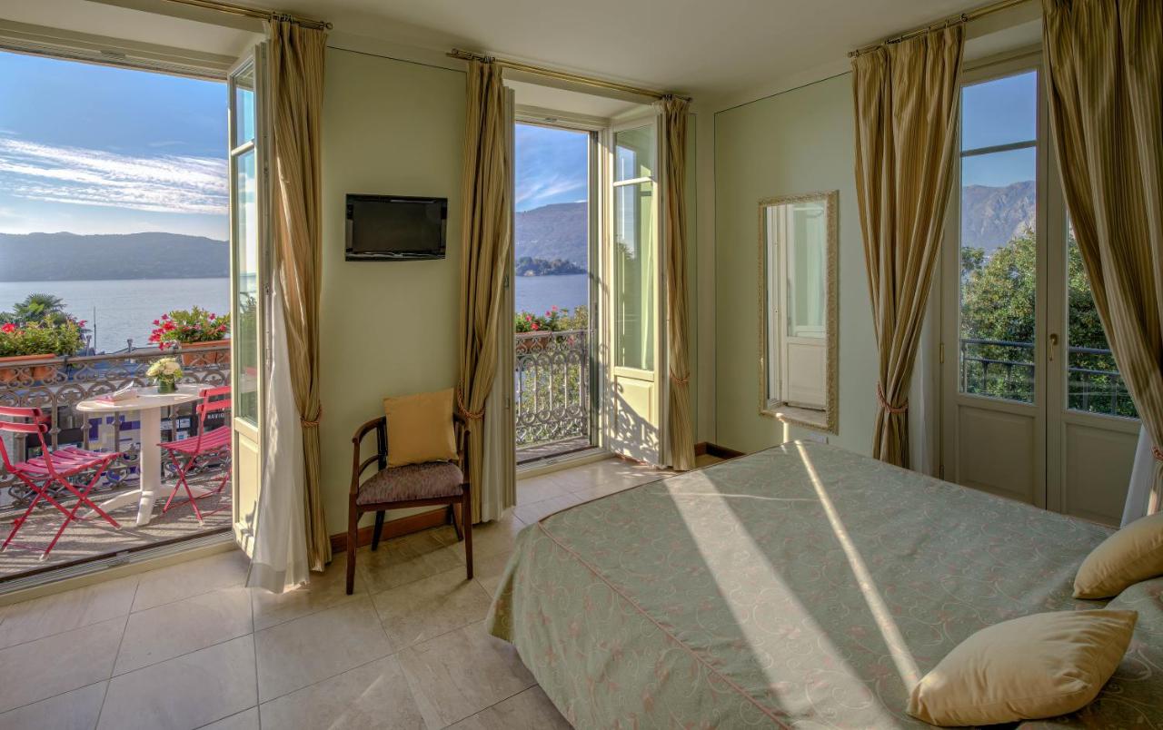 een slaapkamer met een bed en een balkon met uitzicht bij LVG Hotel Collection - Belvedere San Gottardo in Verbania