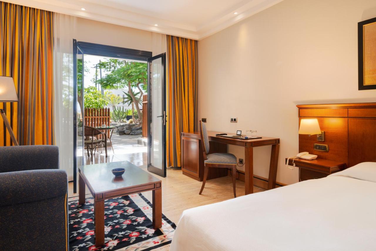 een hotelkamer met een bed en een woonkamer bij Villa VIK - Hotel Boutique in Arrecife