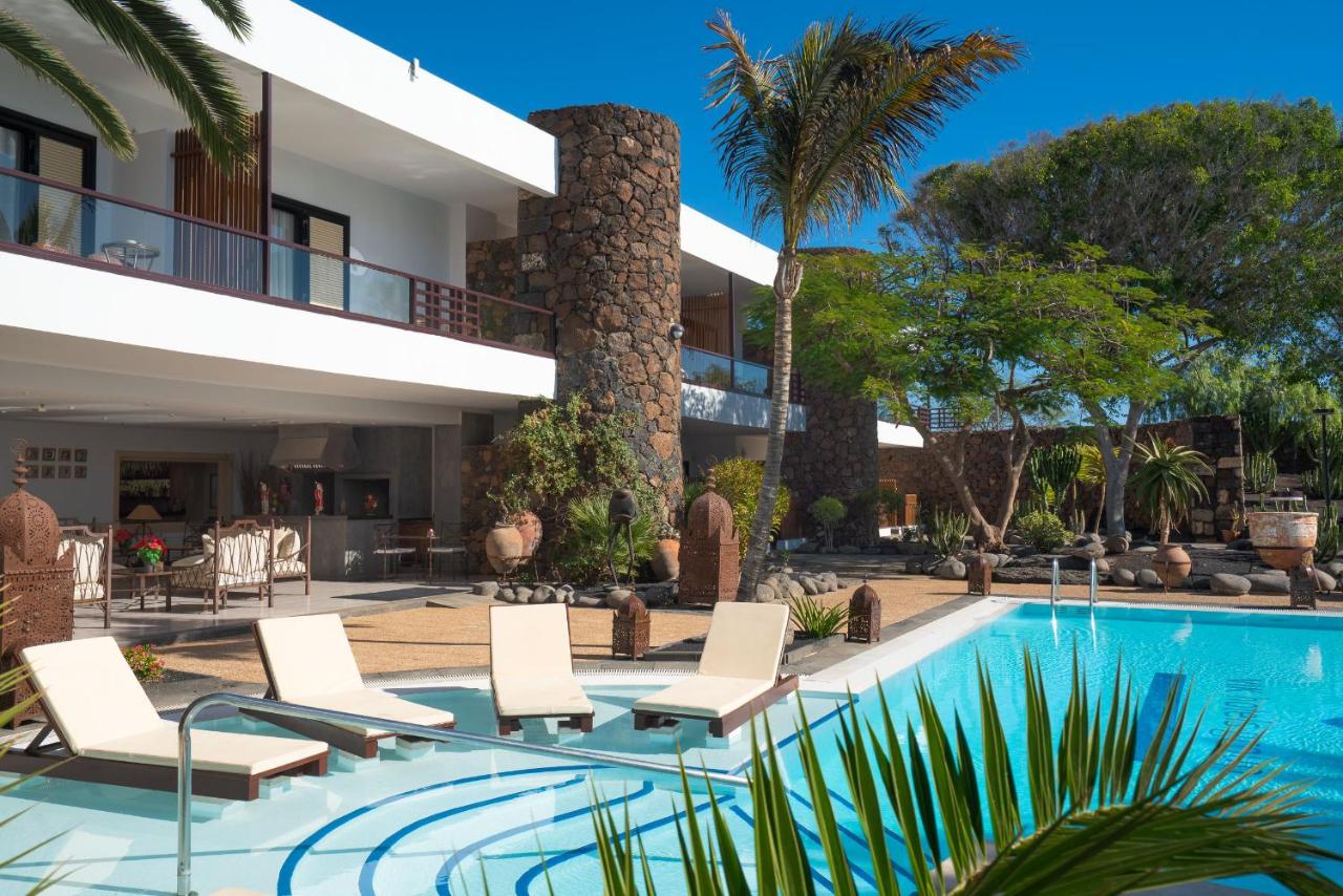 een villa met een zwembad en een resort bij Villa VIK - Hotel Boutique in Arrecife