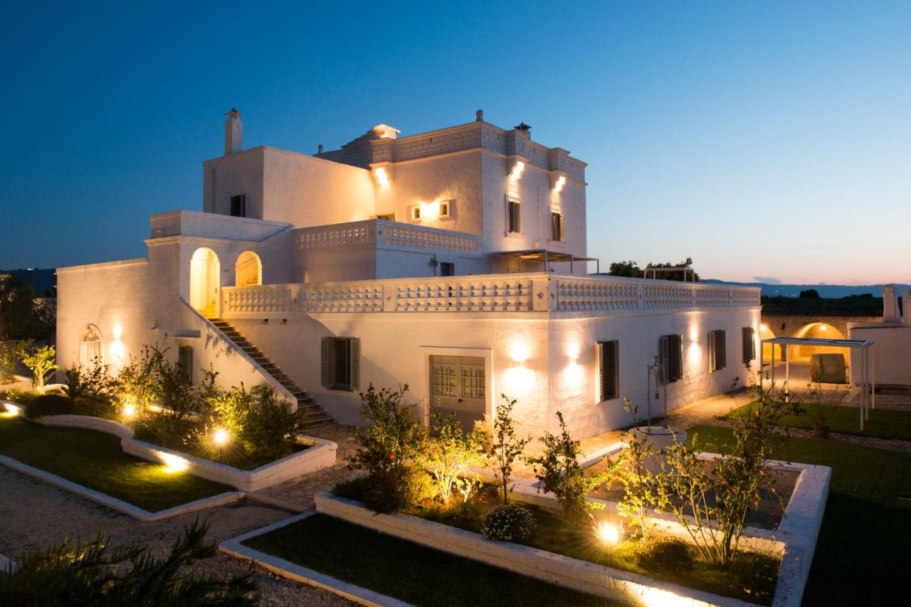 een groot wit gebouw met verlichting ervoor bij Masseria San Giovanni - Epoca Collection in Fasano