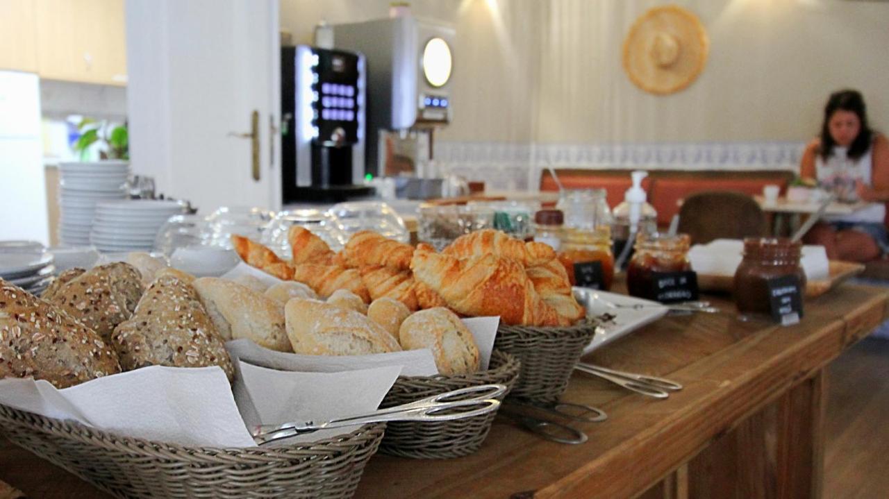 een tafel vol met manden met brood en gebak bij WOT Ericeira in Ericeira