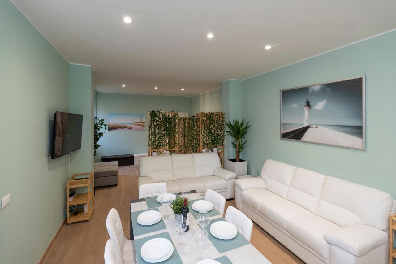 een woonkamer met een witte bank en een tafel bij garda garden apartment in Roe