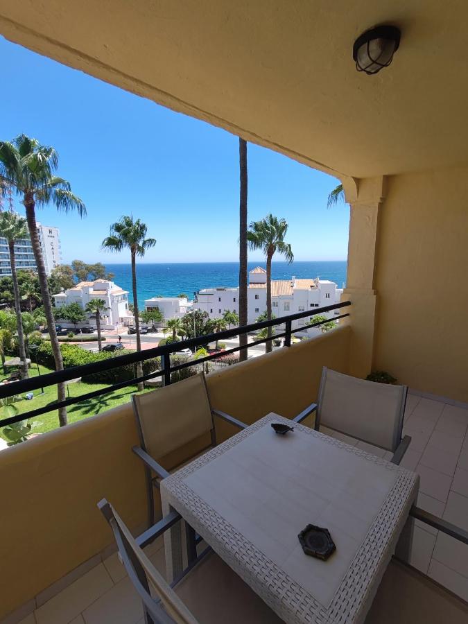 Een tafel en stoelen op een balkon met uitzicht op de oceaan. bij Casinomar in Benalmádena