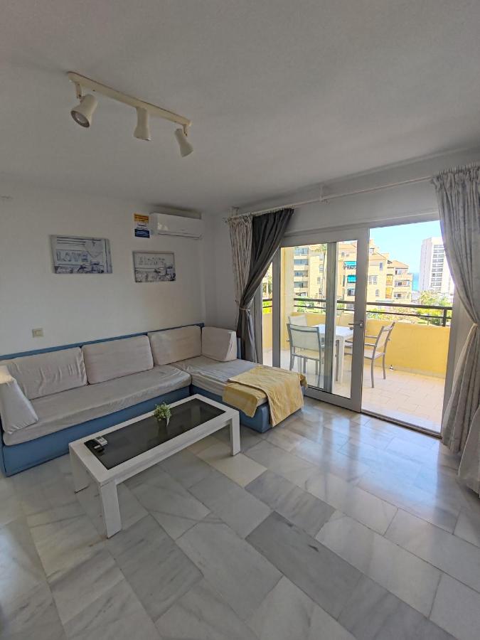 een woonkamer met een bank en een tafel bij Casinomar in Benalmádena